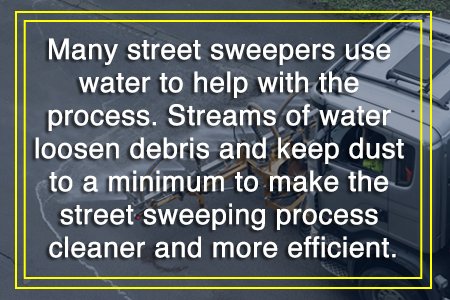 A street sweeper uses water to loosen debris and minimize dust, enhancing the efficiency of the street cleaning process.